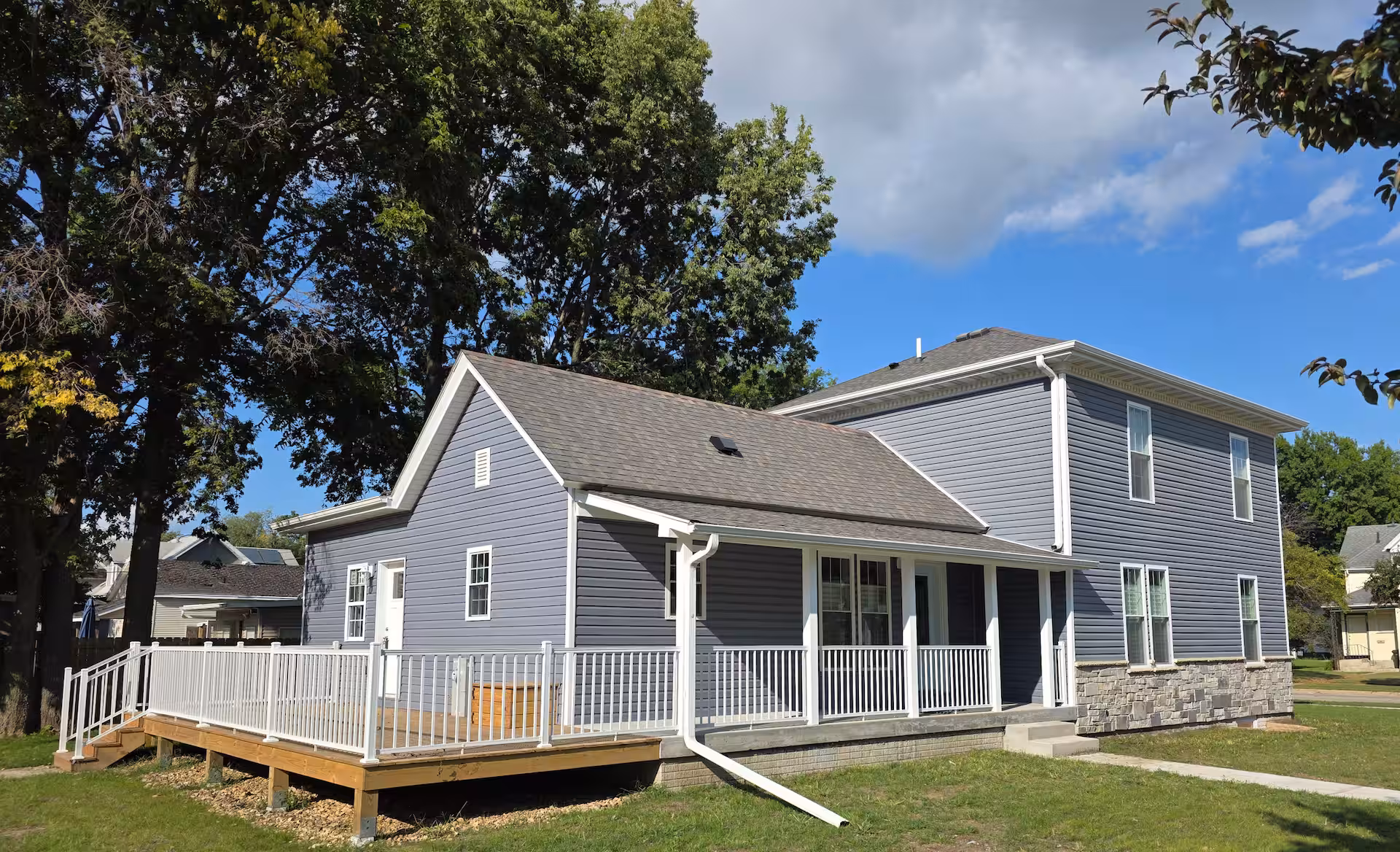 Cedar Falls Retreat exterior — blue siding with stone accent